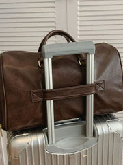 Brown faux leather travel organizer bag with top handles and a detachable strap.