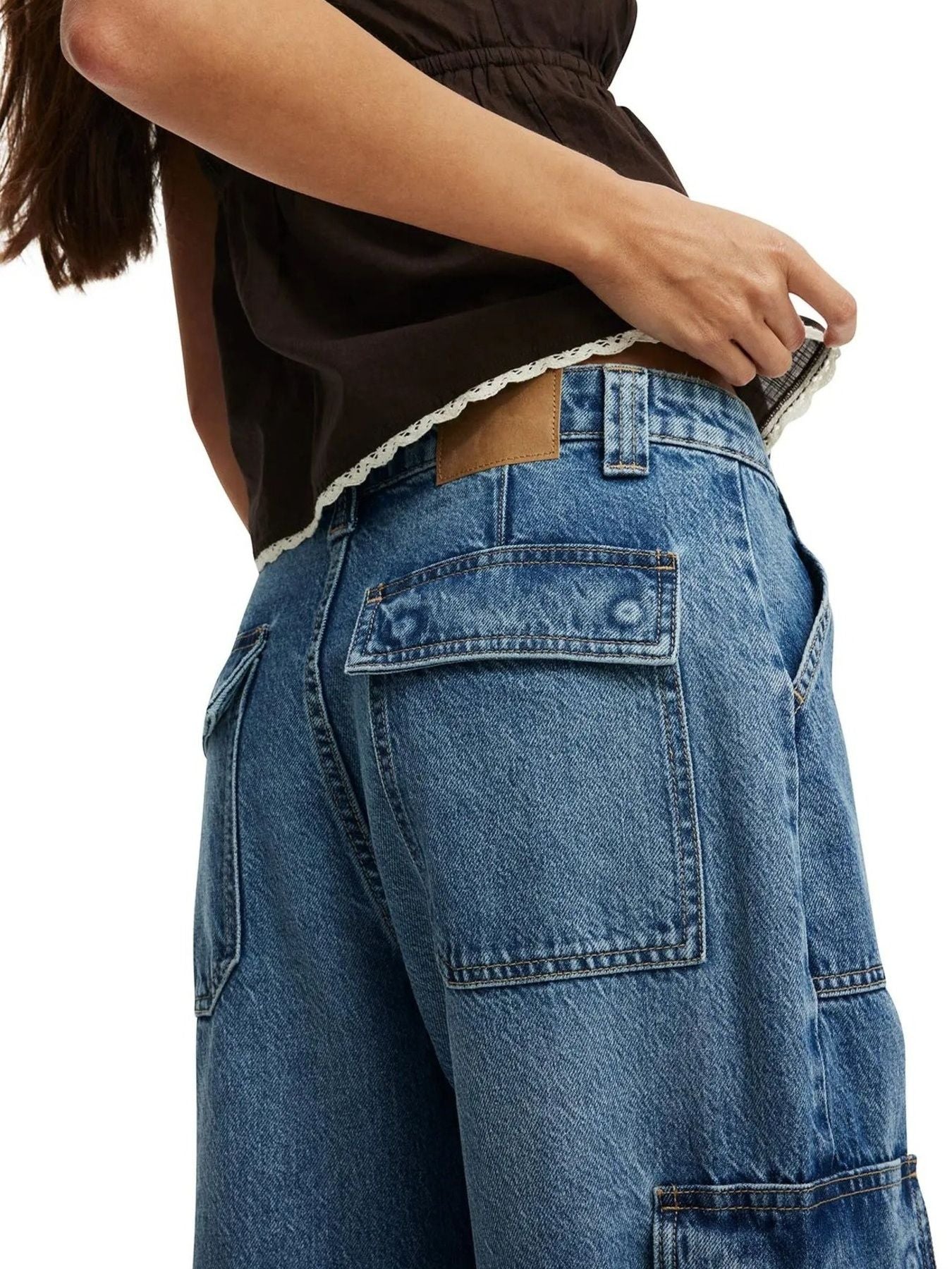 Light blue denim wide leg cargo pants with buttoned flap pockets.