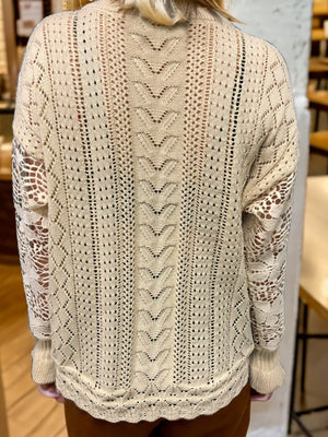 Tan lace sleeve knit cardigan with open knit details and textured back panel.