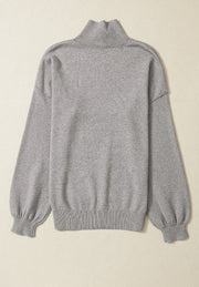 Gray knit sweater with mock neck and balloon sleeves
