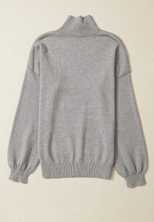 Gray knit sweater with mock neck and balloon sleeves