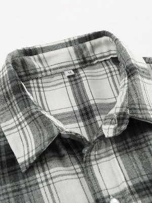 Button-up long sleeve shirt in black and white plaid cotton with a classic collar.