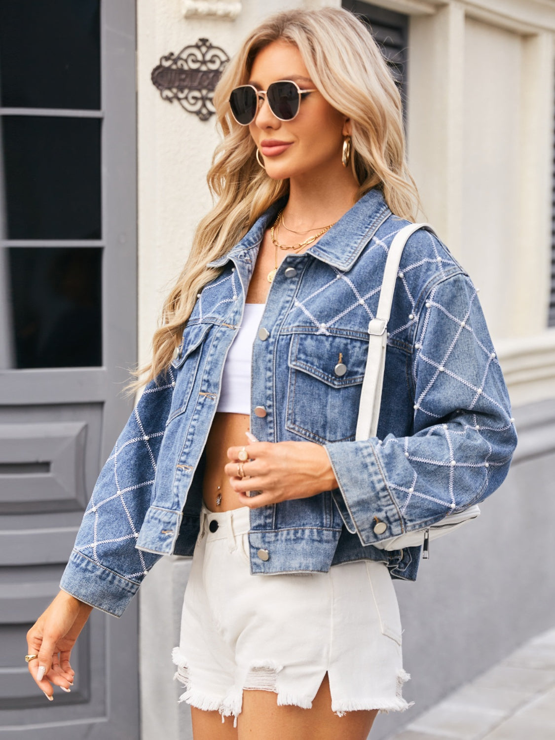 Diamond stitch denim trucker jacket in dusty blue with pearl accents.