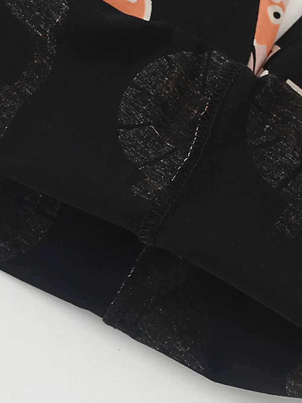 Black cotton blend baby tee with playful lion print and crew neck detail.
