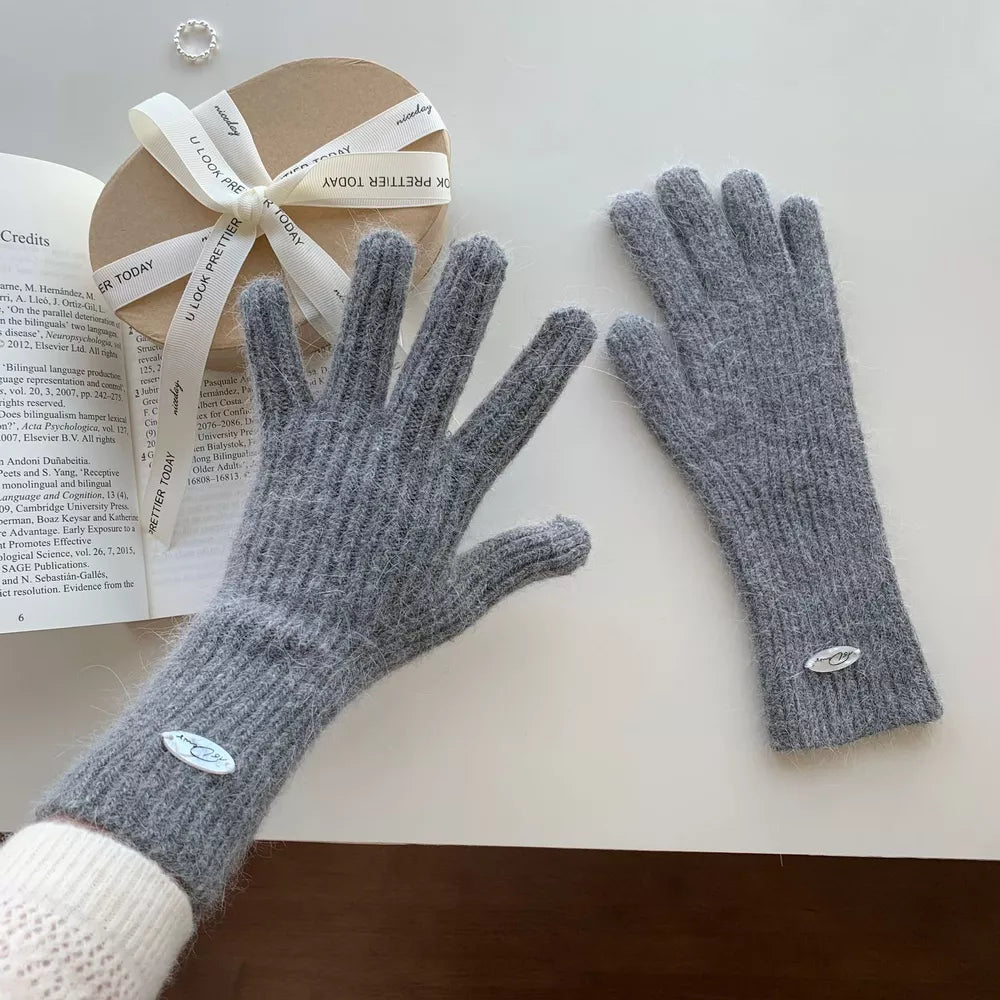 Gray ribbed knit touchscreen gloves with a fuzzy texture and oval logo detail.
