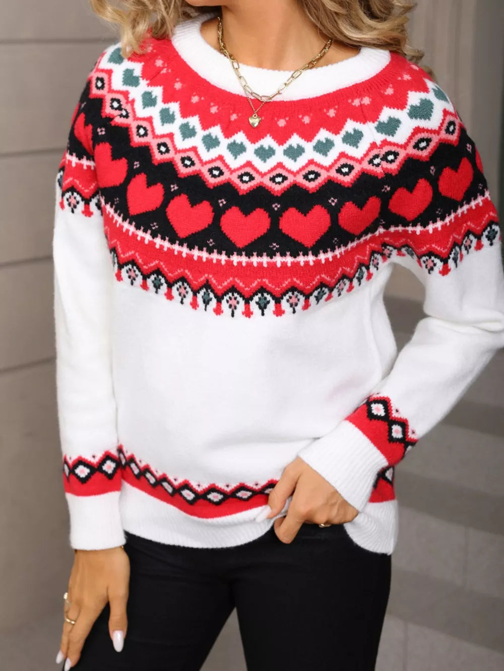 White acrylic sweater with red heart motif, crew neck, and fair isle pattern.