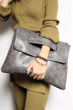Timeless Envelope Clutch in distressed leather, light gray, with cut-out handle detail.