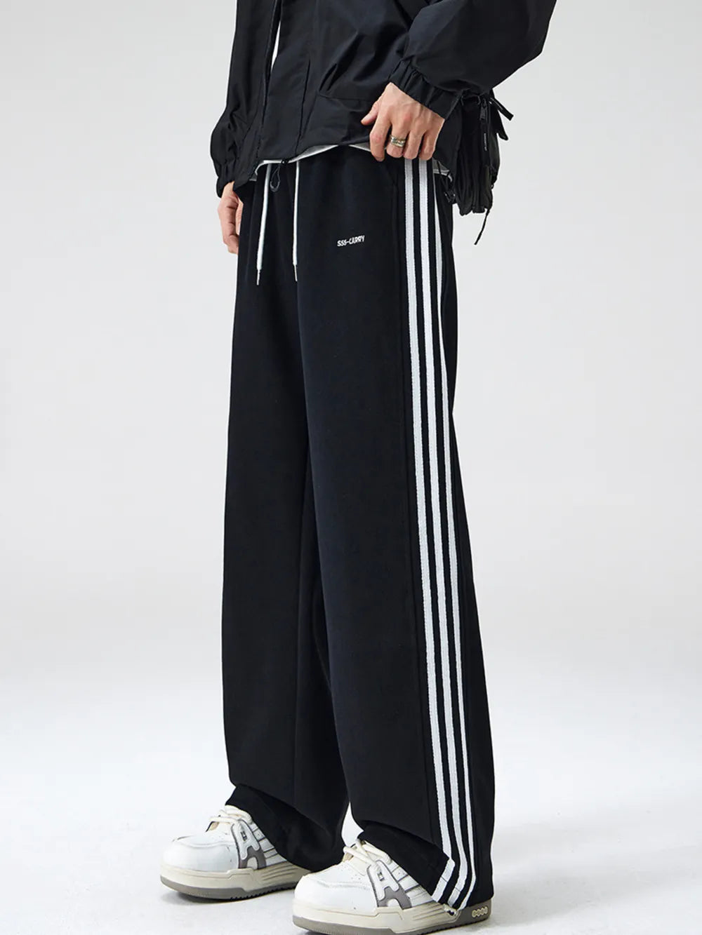 Men's black sweatpants with white side stripes and drawstring waist