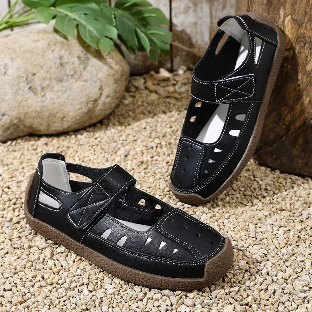Black round toe platform shoes with cutouts and white stitching.