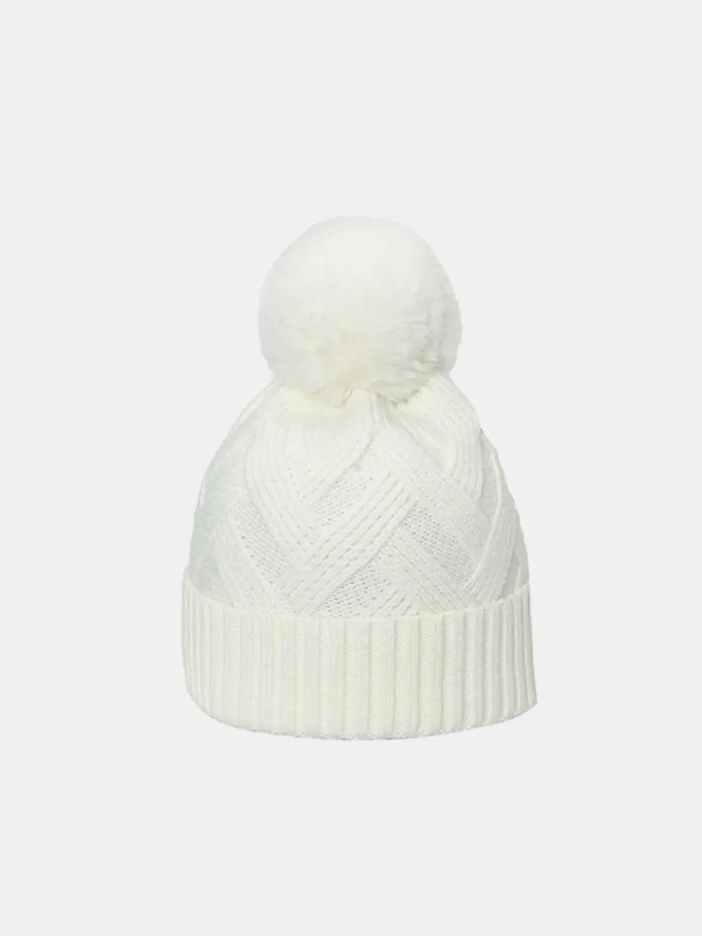 Ivory cable knit beanie with a white pompom and ribbed cuff