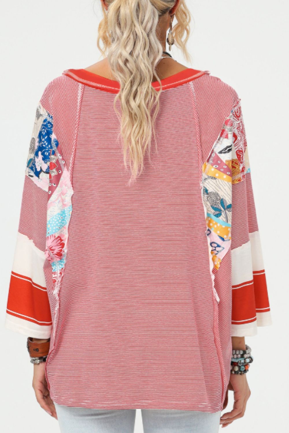 Patchwork stripe raglan sleeve tee in deep red with colorful floral print panels on sleeves.