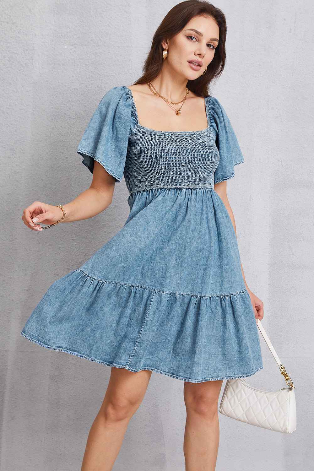 Light denim puff sleeve prairie dress with smocked bodice and tiered skirt.