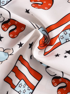 Toddler outfit fabric with patriotic print of American flags and stars on white cotton.