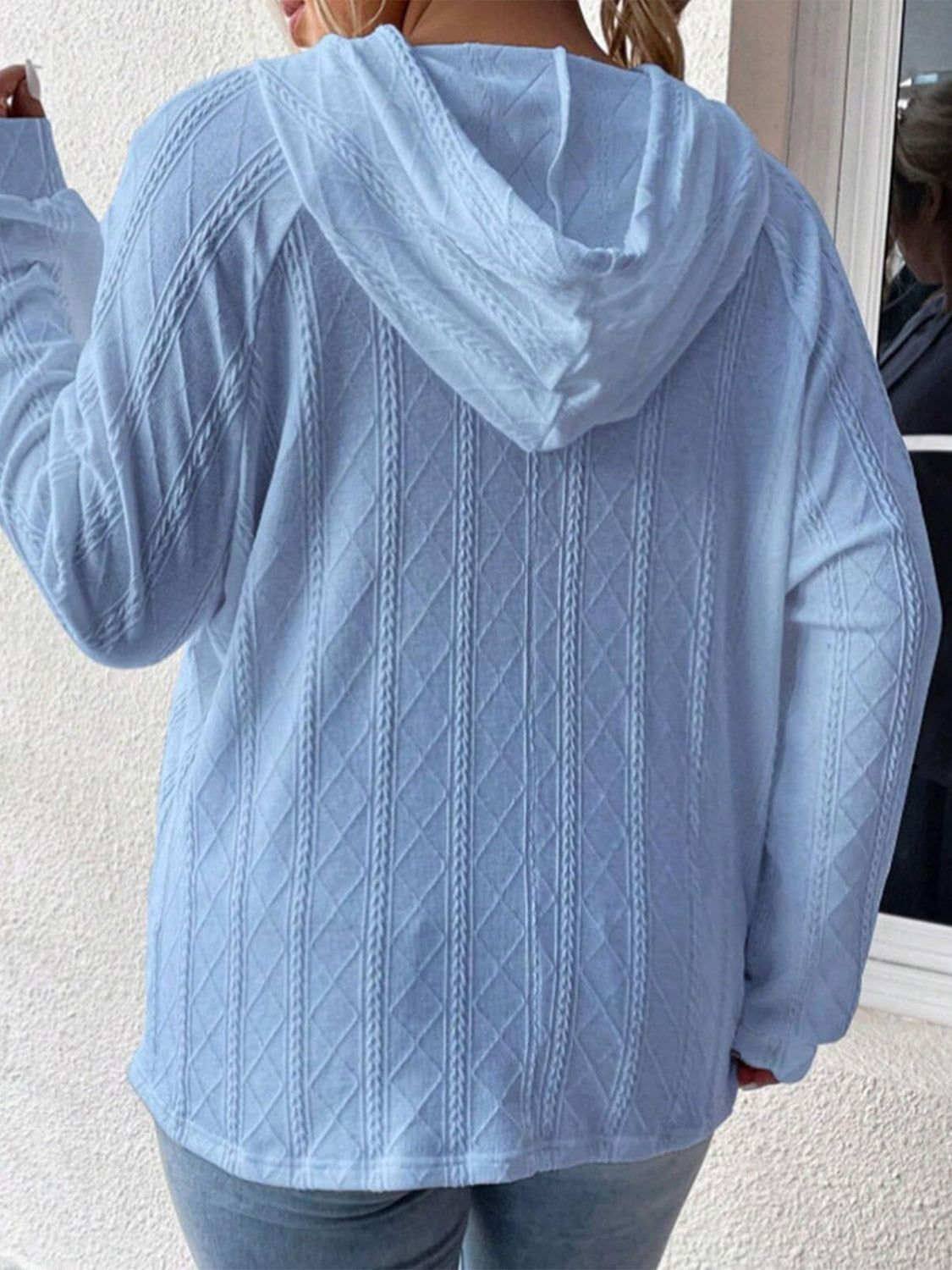 Light blue textured knit raglan hoodie with diamond cable pattern.