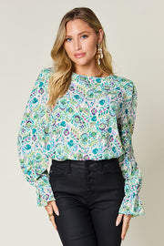 Painterly print blouse with gathered neckline and sleeves in blue and green abstract pattern.