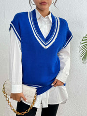 Blue acrylic knit vest with white contrast trim and V-neck, styled over a white shirt.