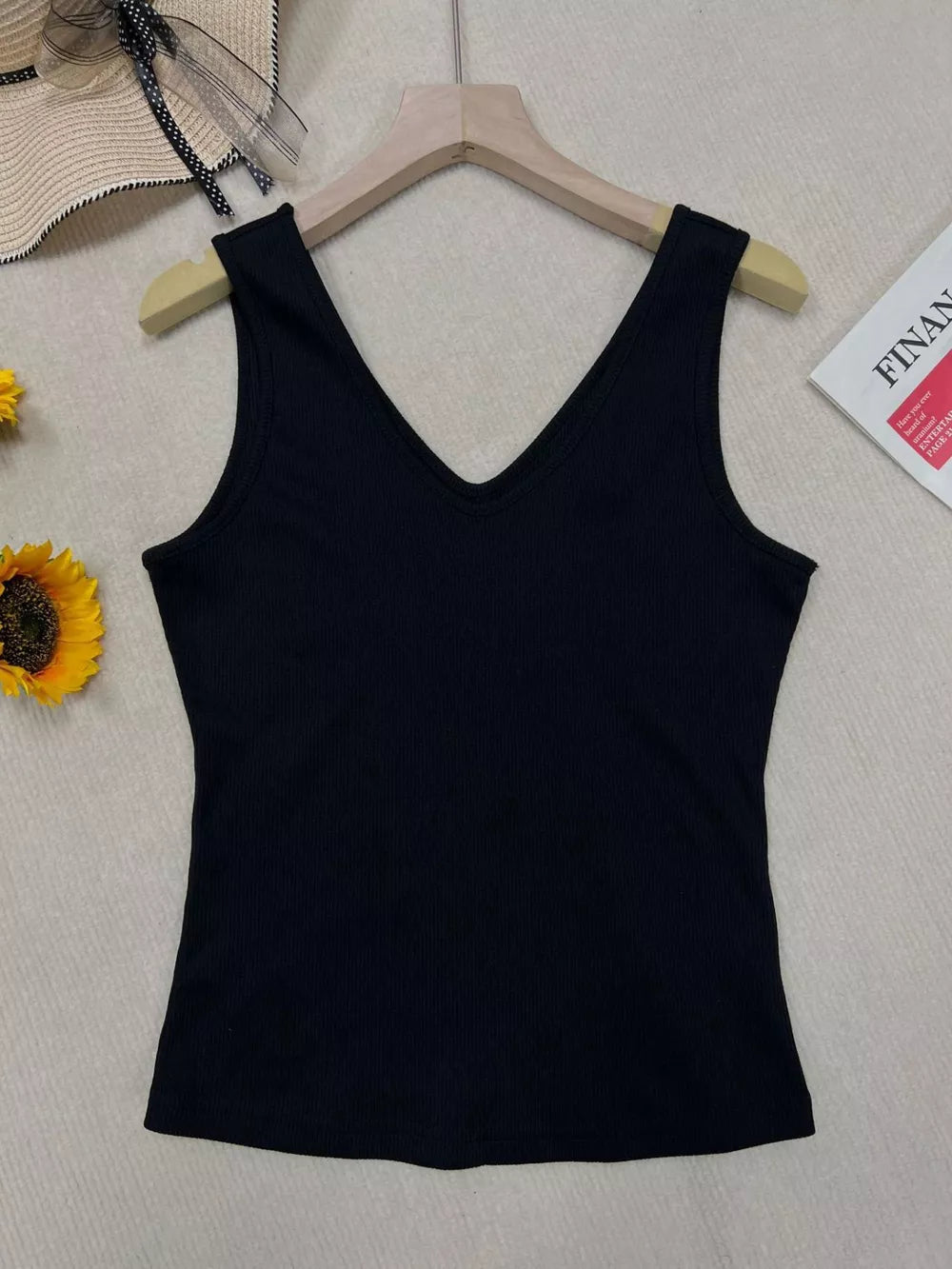 Black ribbed V-neck tank top with a fitted silhouette.