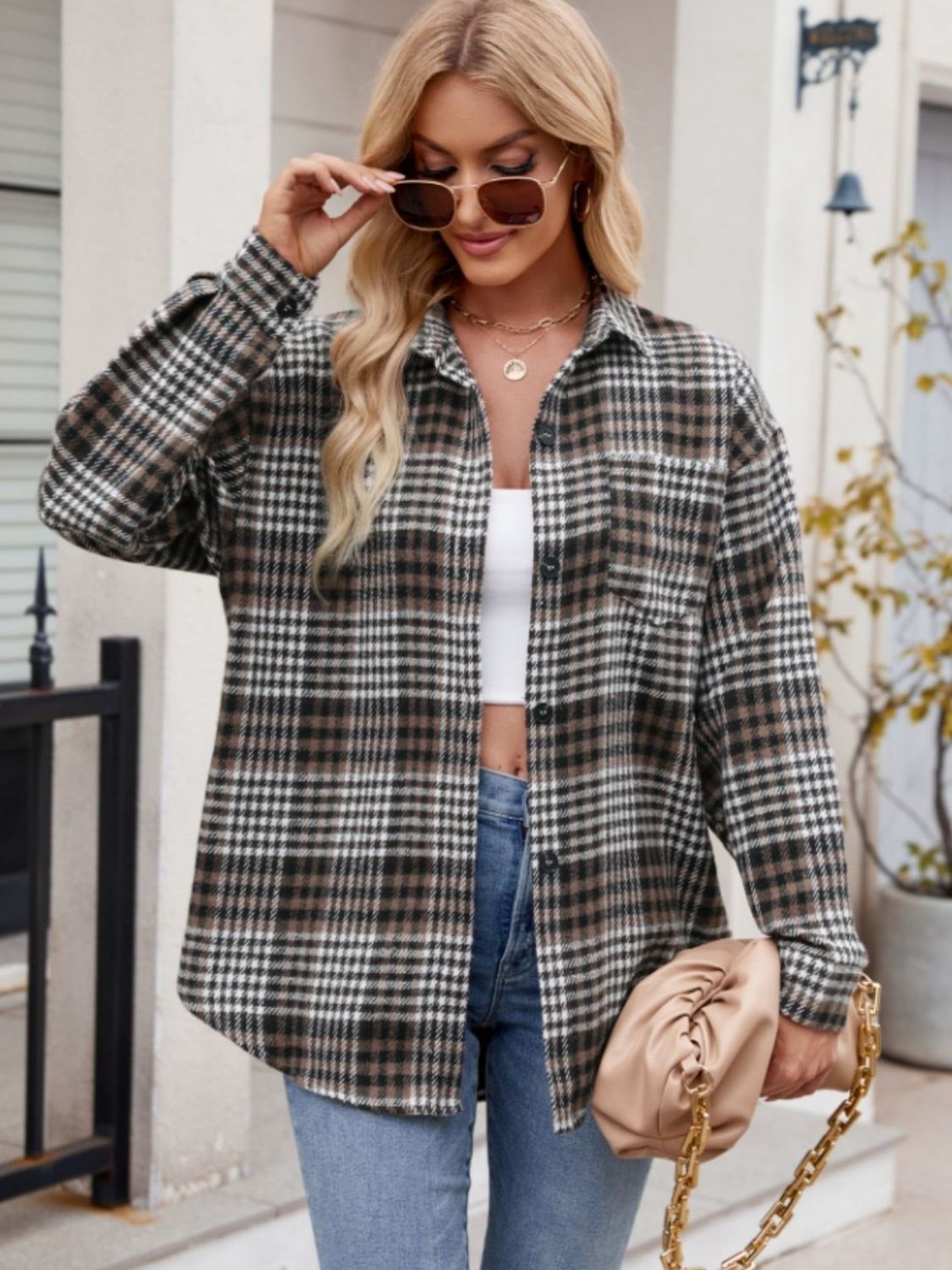 Oversized plaid shirt jacket in brown, black, and white with a chest pocket.