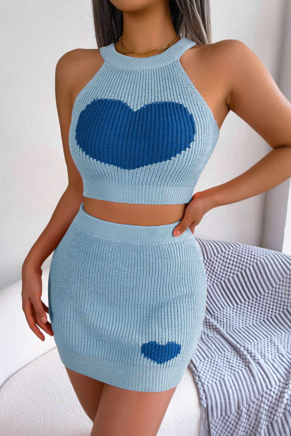 Sky blue knit halter crop top and mini skirt set with intarsia heart details.
