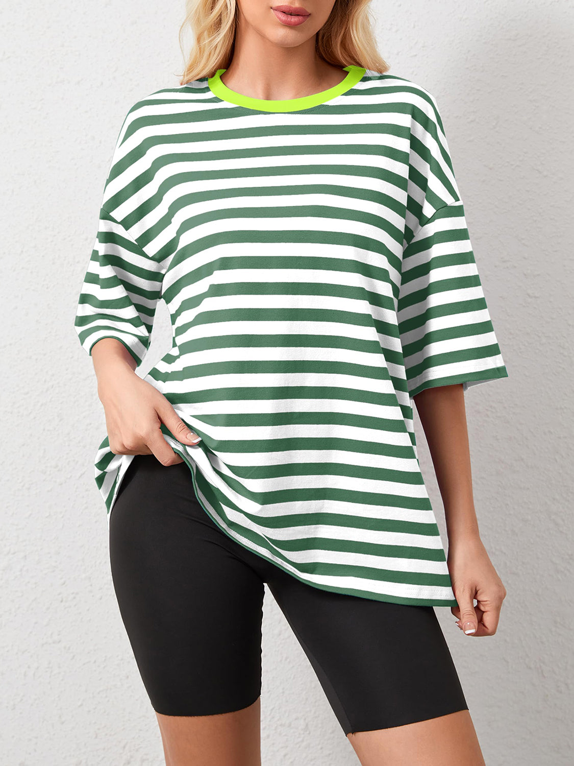 Oversized striped tee in dark green and white with dropped sleeves and a neon green neckline.
