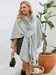 Gray faux fur collar wrap poncho with tie detail and pom-pom accent.