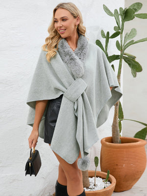 Gray faux fur collar wrap poncho with tie detail and pom-pom accent.