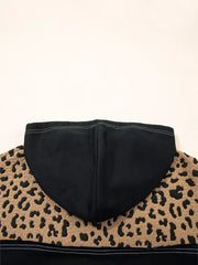 Leopard print hoodie with black hood and textured fabric detail.