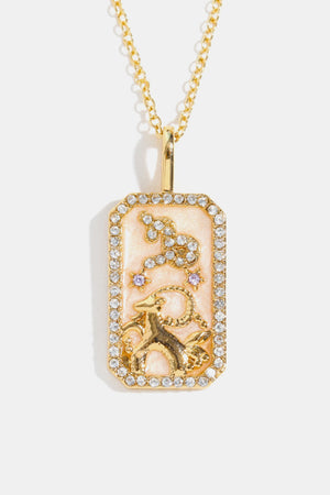14K gold-plated Capricorn zodiac sign crystal pendant necklace with a pink enamel background.