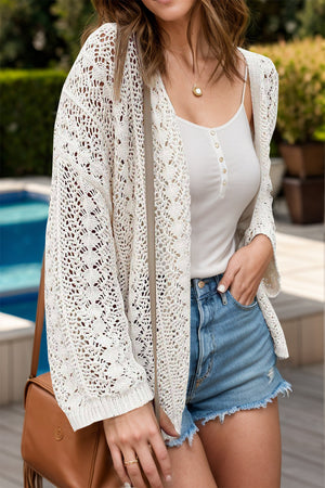 White open-knit crochet cardigan with intricate lace pattern and long sleeves.