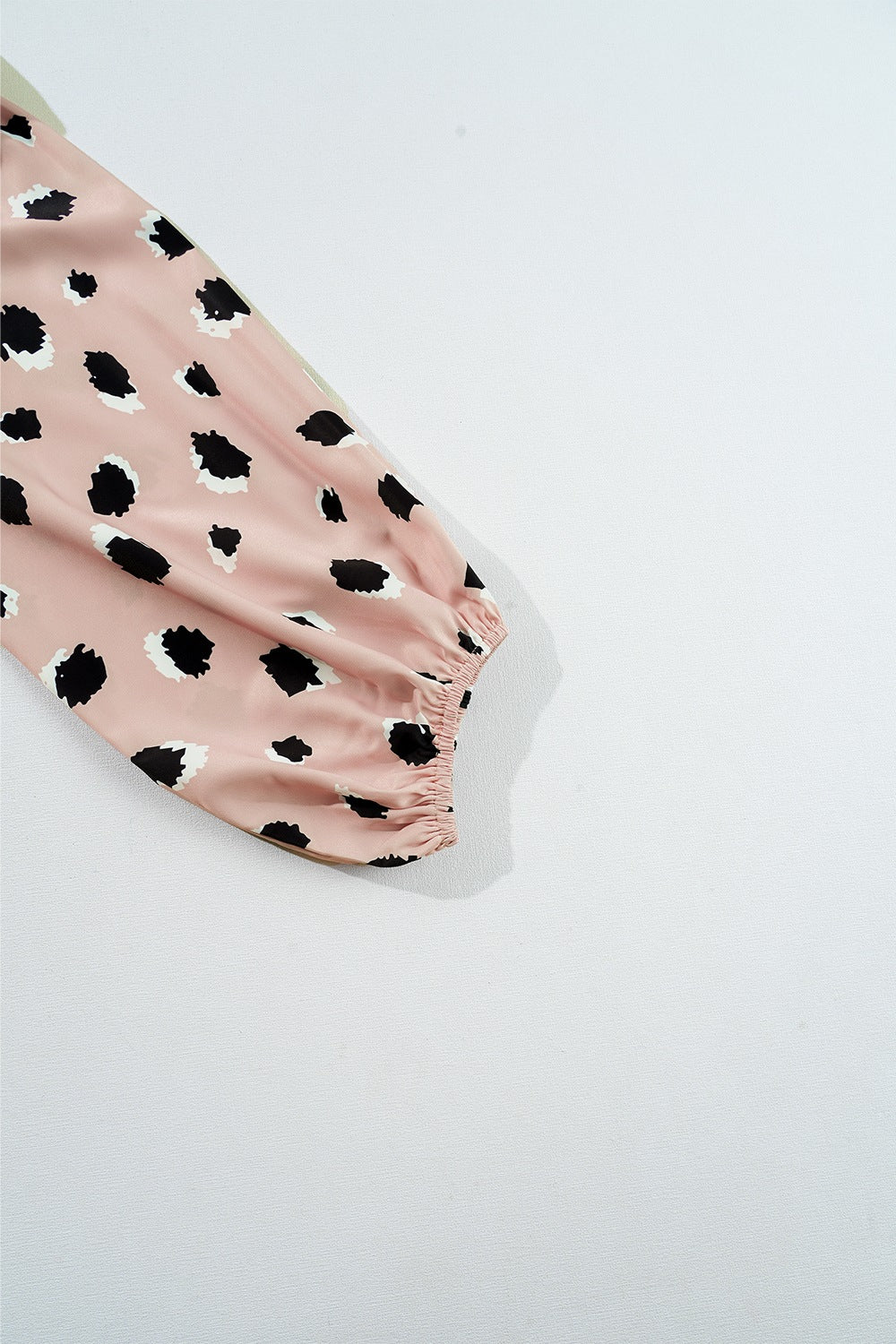 Blouson sleeve blouse in dust storm pink with black spot print and elastic cuff.