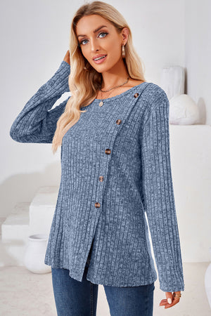 Dusty blue ribbed knit sweater with asymmetric button detail and crew neck.
