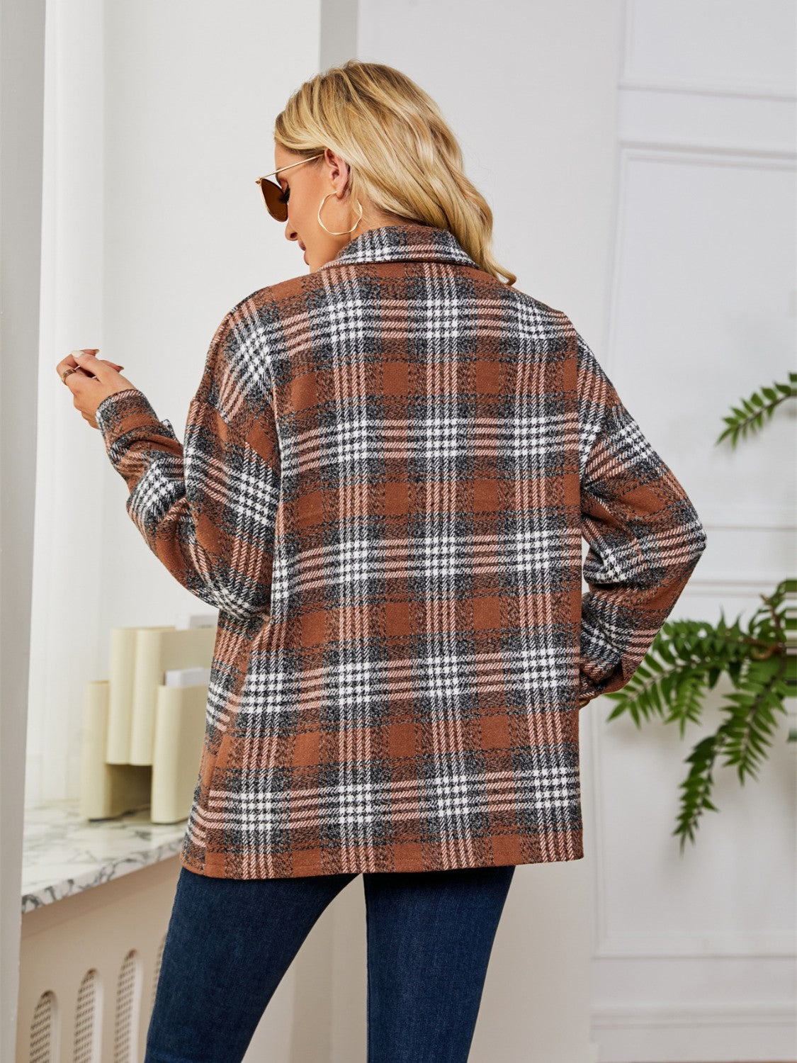 Brown plaid shacket with oversized buttons and a collared neckline.