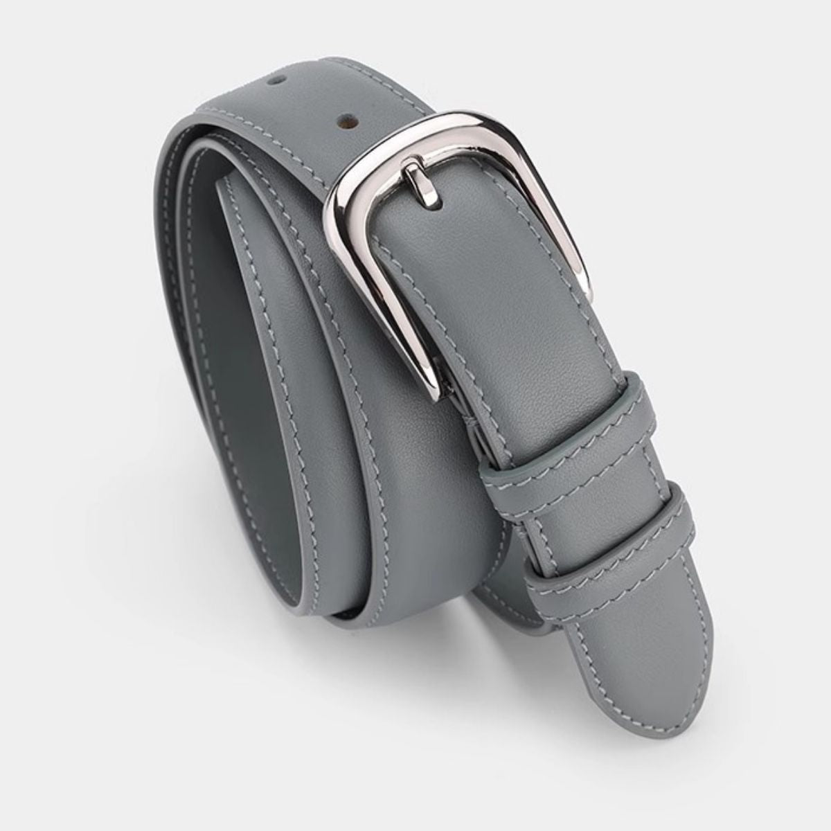 Timeless cowhide leather slim belt in blue gray with silver buckle and contrast stitching.