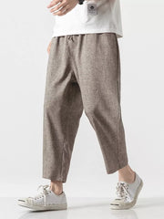 Men's relaxed fit cropped sweatpants in brown with a drawstring waist.