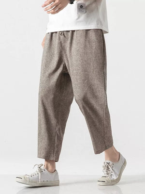 Men's relaxed fit cropped sweatpants in brown with a drawstring waist.