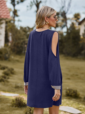 Navy cold shoulder mini dress with lace trim on cuffs and open shoulders.