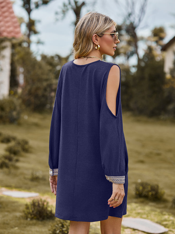 Navy cold shoulder mini dress with lace trim on cuffs and open shoulders.