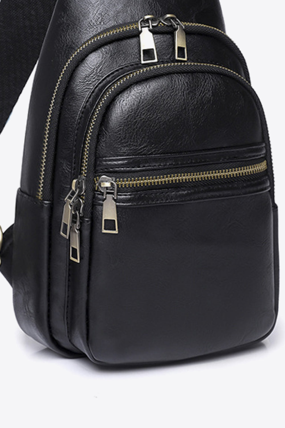Black geometric strap sling bag with multiple zippered pockets and gold-tone hardware.
