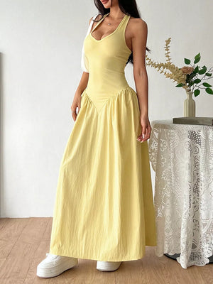 Yellow V-neck ruched maxi dress with empire waist and flowy skirt.