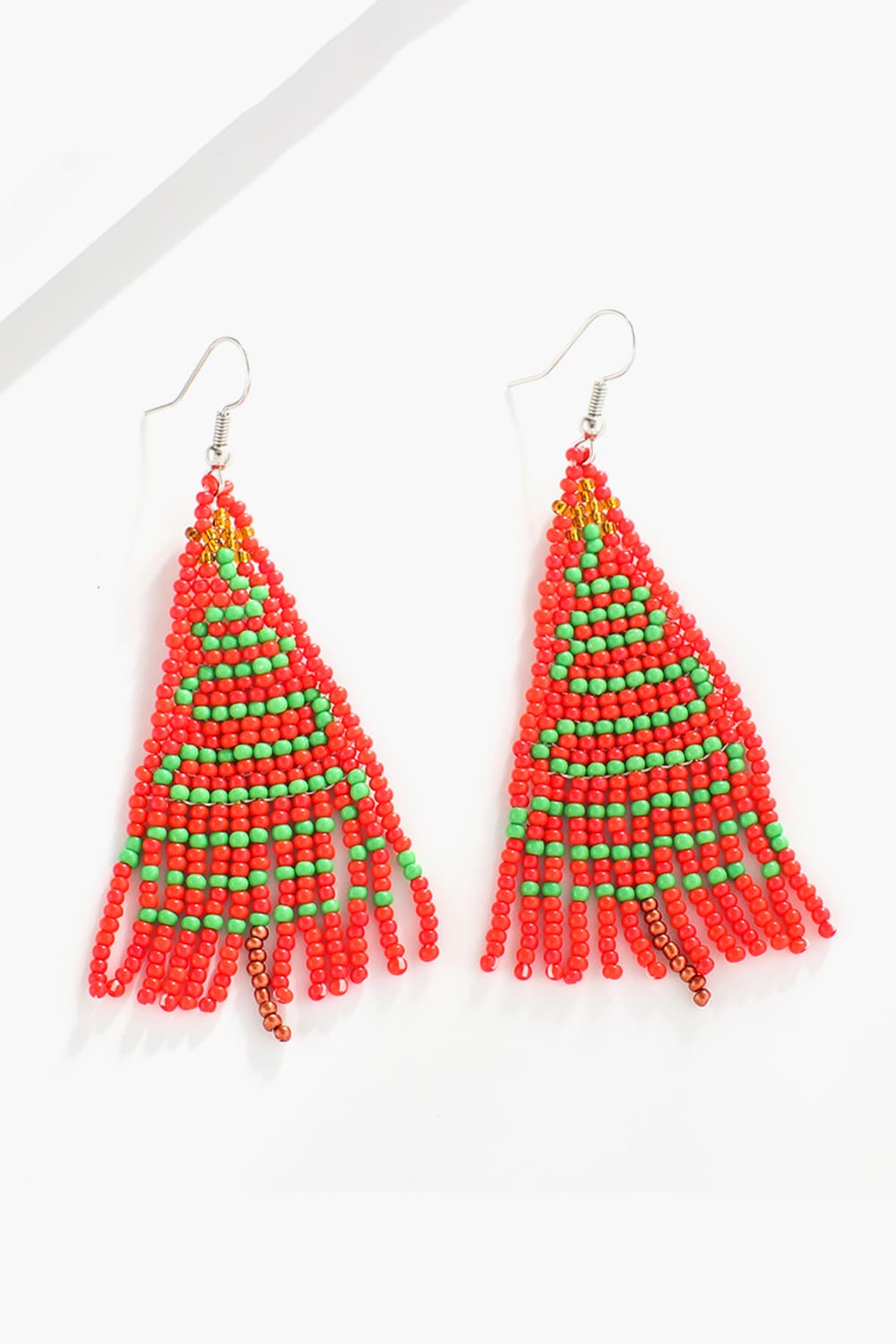 Beaded Christmas tree drop earrings in red and green with fringe detail.