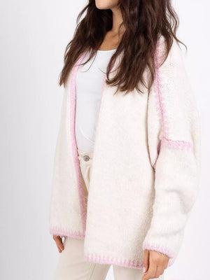 Oversized cream cardigan with contrast dusty pink trim and stitching detail.