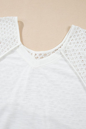 White blouse with lace inset dolman sleeves and V-neck detail