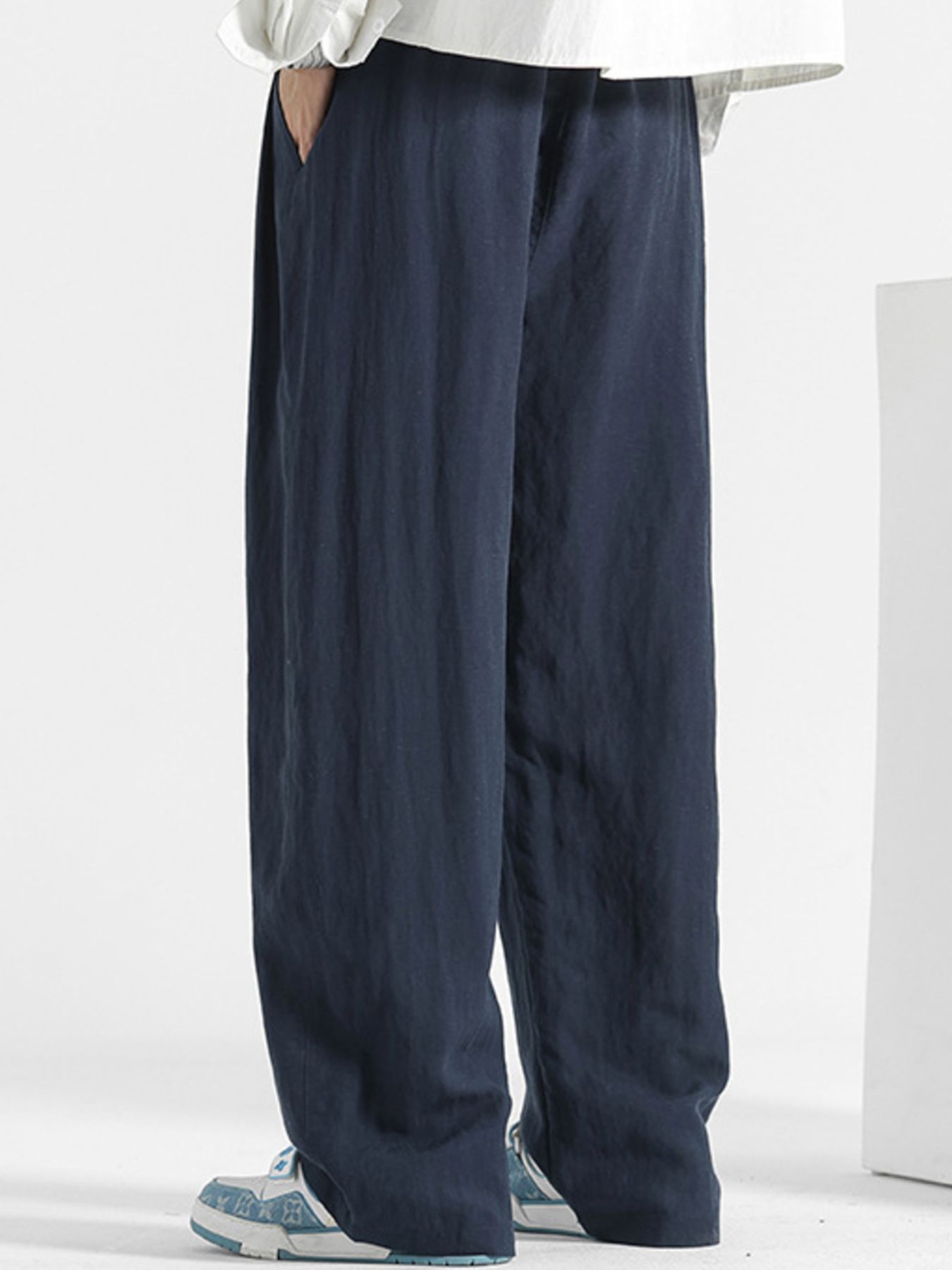 Men's navy blue relaxed fit sweatpants with side pockets.