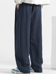 Men's navy blue relaxed fit sweatpants with side pockets.