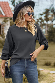 Dark Gray waffle knit eyelet raglan sleeve top with crewneck and cuffed sleeves.