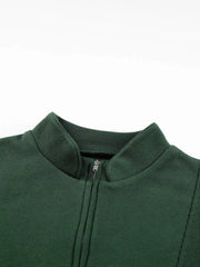 Dark green half zip sweatshirt with stand collar and ribbed details.