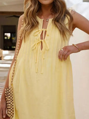 Yellow tie-front mini dress with vertical pintucks and a keyhole neckline.