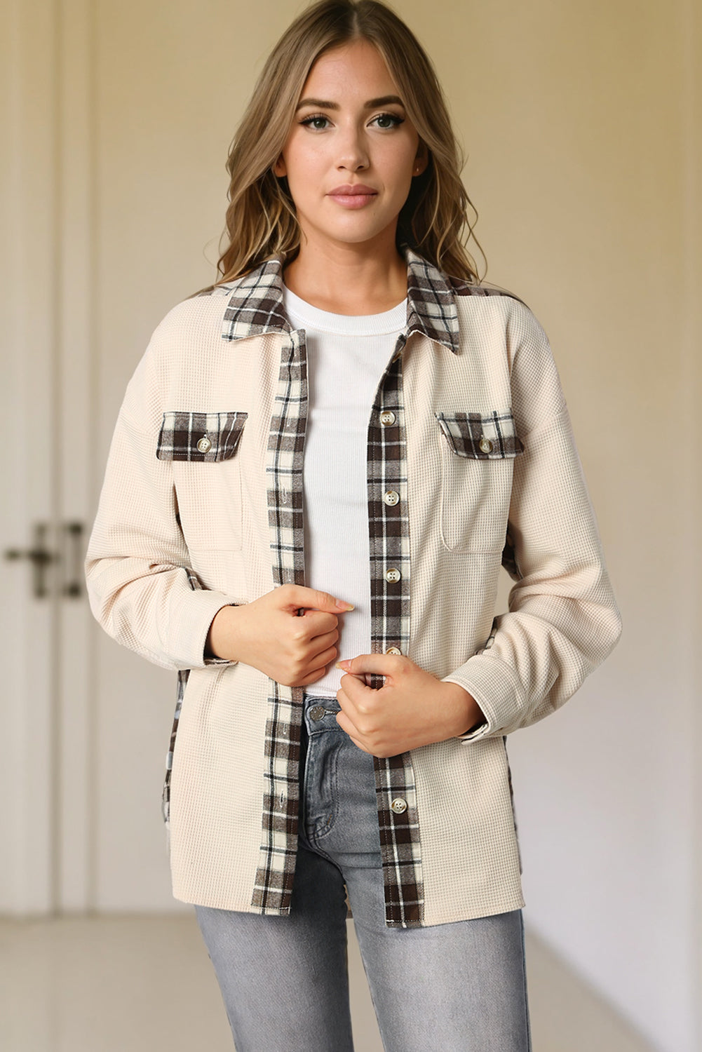 Cream waffle knit overshirt with plaid trim and button pockets, styled open over a white tee.