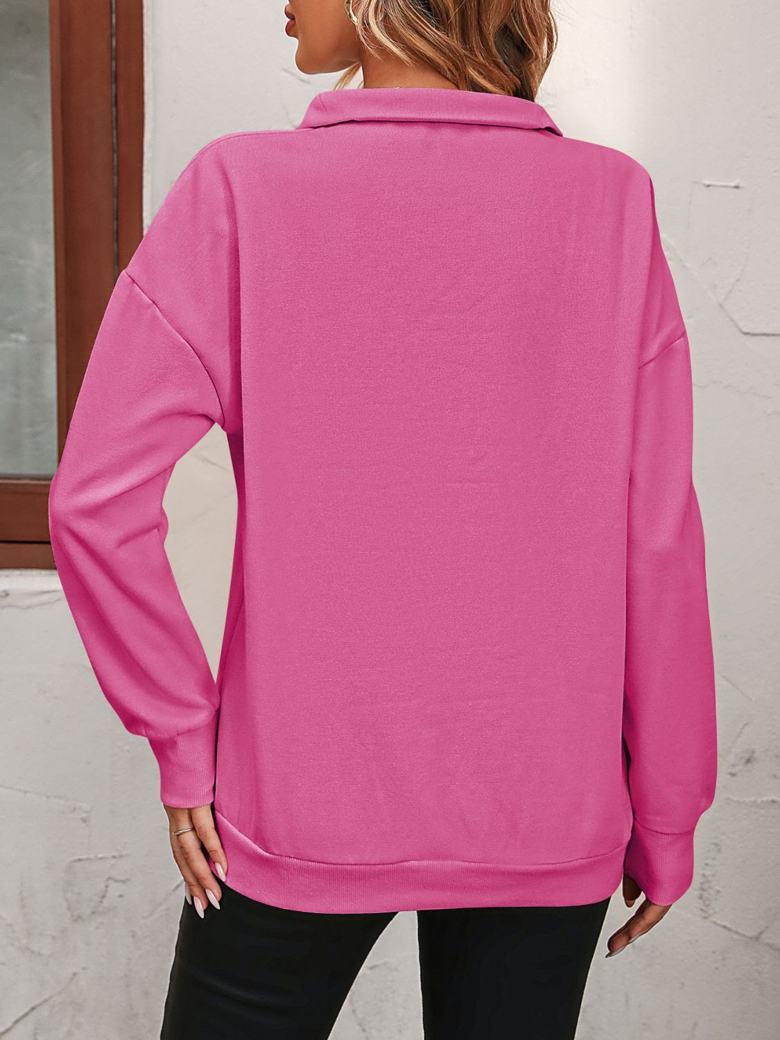 Hot Pink quarter-zip relaxed fit sweatshirt with collar and long sleeves.