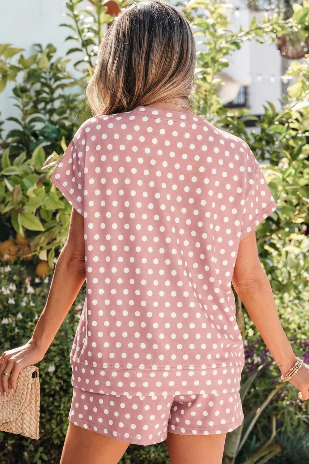Pink polka dot tee and shorts set made of polyester.